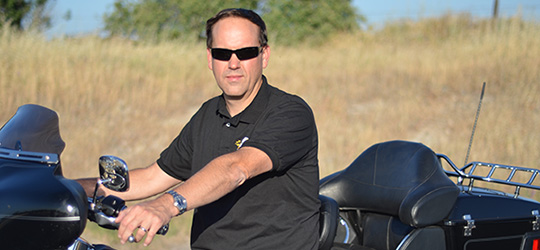 Motorcycle attorney Frank Penney sitting on a motorcycle