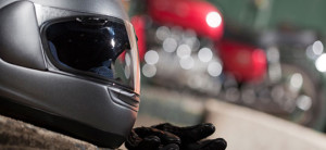 A close up of a motorcycle helmet and gloves. California motorcycle lawyer Frank D. Penney gives biker safety tips