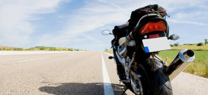 Motorcycle stopped on a wide and empty road. Motorcycle resources can provide tips, communities, and relevant information on riding your bike